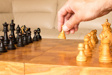 A chess pawn in a human hand. The beginning of the chess game. The concept of chess.