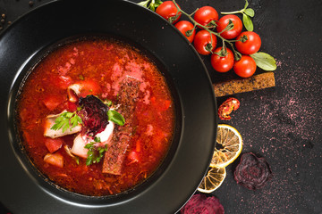 Red ukrainian soup borsch on black background