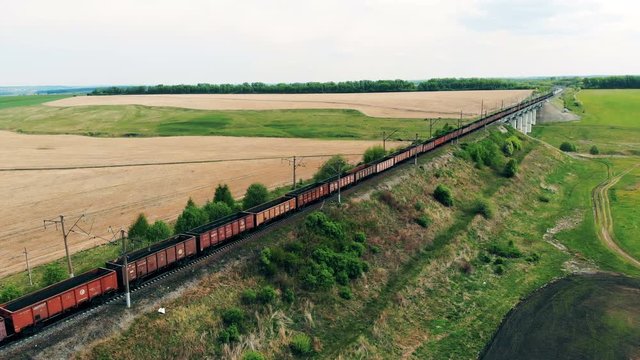 Aerial freight train on a long railroad, top view.