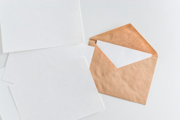 Mockup of envelope and blank white paper on white background
