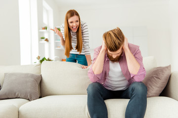 Ginger red hair bad dispute leave jealous misunderstanding people concept. Angry irritated lady shouting at boyfriend. He is covering closing ears with hands palms doesn't want to listen to wife