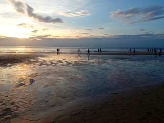 beautiful sunset on the beach people walking