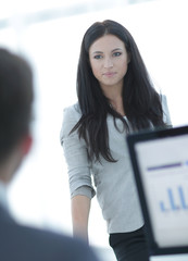 successful business woman standing near a work table