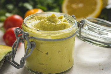 Homemade Green Avocado Spread in Jar. Vegan Raw and Healthy Fresh Food Concept.