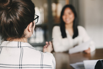Business, career and placement concept -photo from back of businesswoman interviewing, and talking...