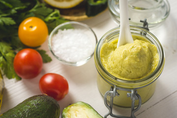 Homemade Green Avocado Spread in Jar. Vegan Raw and Healthy Fresh Food Concept.