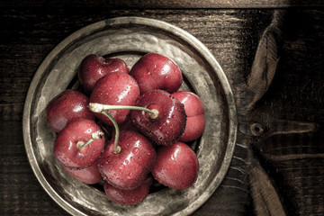 Wet Fresh Red Cherries in Rustic Plate