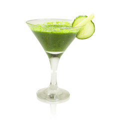 Green vegetable smoothie with celery, spinach and herbs in Martini glass on white isolated background. The concept of healthy eating.