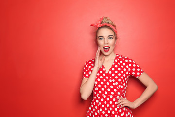 Portrait of emotional young woman on color background