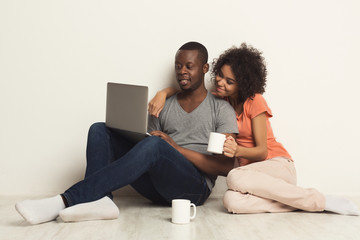 Happy african-american couple shopping online