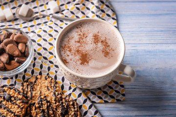 Cup of tasty cocoa drink on wooden table