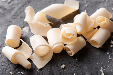 Chocolate curls on grey textured background