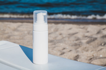 Spray sunscreen on the sea beach