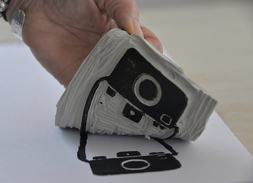 Woman lifting a printing stencil