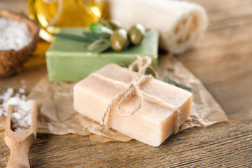 Fototapeta na wymiar Bar of natural soap with olive extract on table