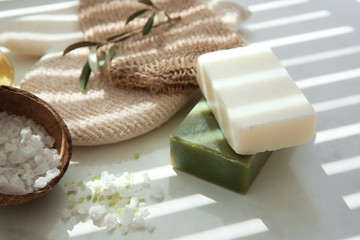 Fototapeta na wymiar Bars of natural soap with olive extract and sea salt on table