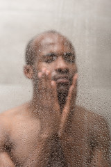 selective focus of handsome young african american man washing in shower