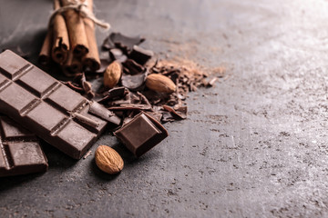 Milk chocolate pieces with almonds on grey background