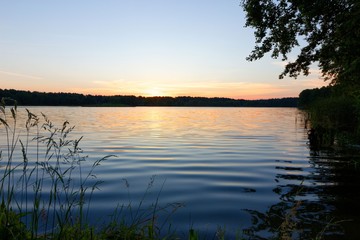 Naklejka na ściany i meble View on a lake during sunrise