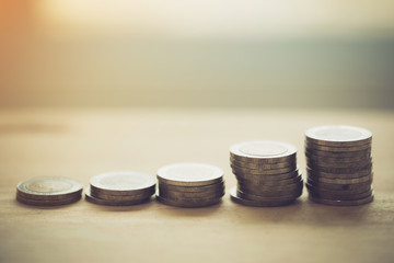 Coin stacks on a wood table background