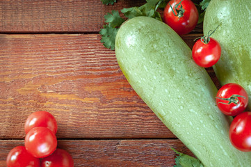 zucchini and tomatoes on.wooden background