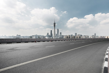 Fototapeta na wymiar empty road with city skyline