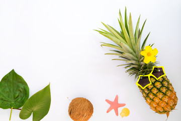 Hipster pineapple fashion with tropical fruit, sea shells and starfish. Summer vacation background concept. Top view, flat lay