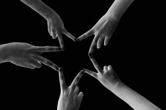 Child's hands make the star isolated on black background