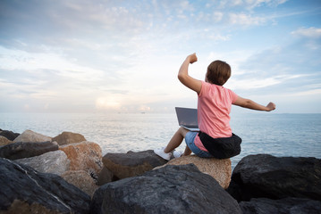 Woman Freelance in pink shirt stretching on the sky.