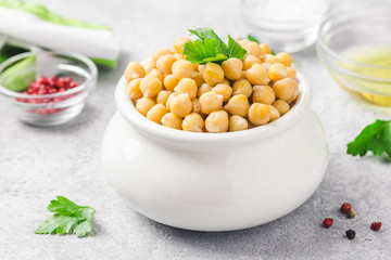 Chickpeas in a pot on concrete background. Selective focus, space for text.