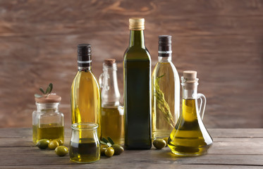 Glassware with olive oil on wooden background