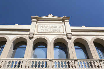 Facade old health mental center, Frenopatico with sign department men, in Les Corts quarter of Barcelona.