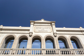 Facade old health mental center, Frenopatico with sign department women, in Les Corts quarter of Barcelona.