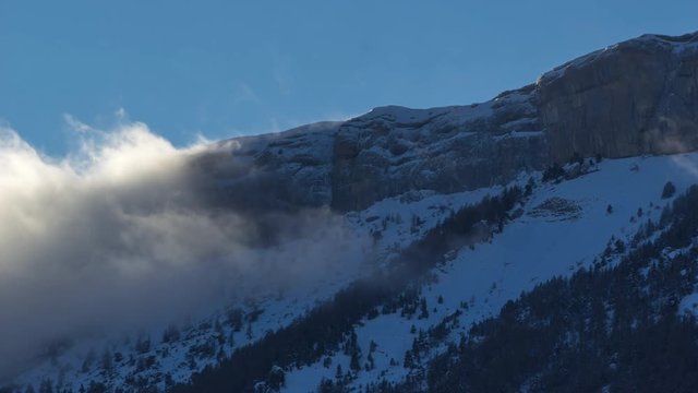Ceuze mountain cliff with passing clouds in Winter (timelapse). Hautes-Alpes, European Alps, France