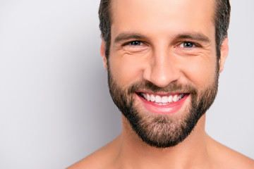 Obraz premium Close up cropped portrait with copy space of cheerful, joyful, virile, manly, attractive, naked, unshaven, handsome, stunning man with ideal, perfect face skin, looking at camera over gray background