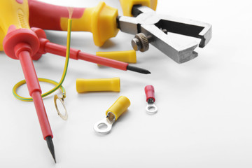 Electrician's supplies on white background