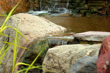 Stones in stream./Stones in stream with smooth flowing water.