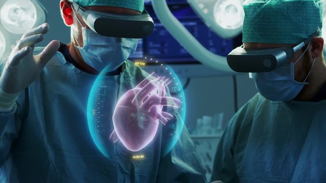 Surgeons Wearing Augmented Reality Glasses Perform Heart Surgery with Help of Animated 3D Heart Model. Doing Difficult Heart Transplant Operation Using Gestures. Shot on RED EPIC-W 8K.