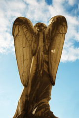Old statue of angel inside the monumental cemetery of the Certosa di Bologna. The public cemetery was established in 1801. BOLOGNA, ITALY