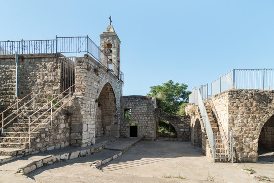 The fasade with the belfry of the functioning church of the Christian Maronites in the abandoned village Kafr Birim in the north of Israel