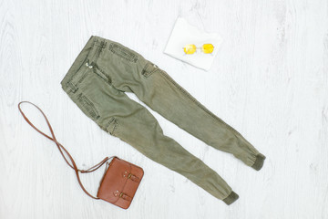 Khaki trousers, handbag and sunglasses. Fashionable concept