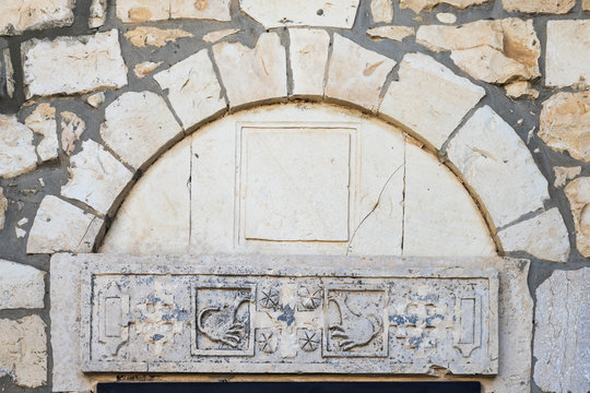 Decorative carvings over the stone in the course of the church of the Christian Maronites in the abandoned village Kafr Birim in the north of Israel