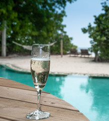 Maldives beautiful beach background white sandy tropical paradise island with blue sky sea water pool champagne glass
