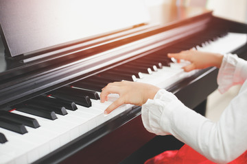 Little asian girl happy to play piano