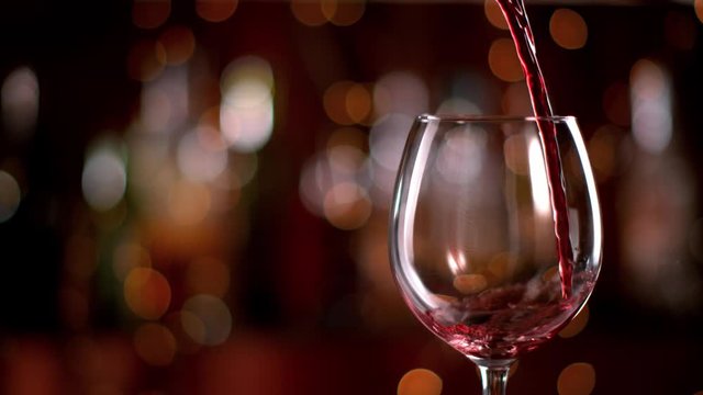 Super slow motion of pouring red wine from bottle into goblet. Shot on high speed cinema camera with 1000fps 4K resolution.