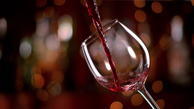 Super slow motion of pouring red wine from bottle into goblet. Shot on high speed cinema camera with 1000fps 4K resolution.