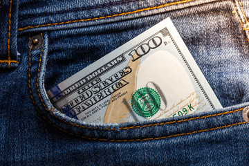 100 dollar banknote in jeans pocket