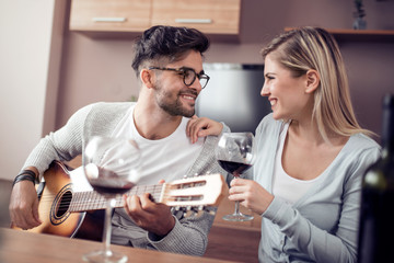 Happy lovely couple drink red wine