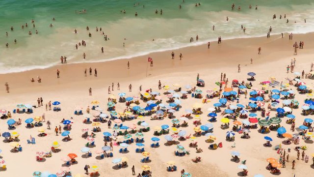 People swimming and sunbathing on Copacabana beach in Rio de Janeiro, Brazi, South America - 4K Time lapse