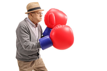 Mature man wearing a pair of big boxing gloves